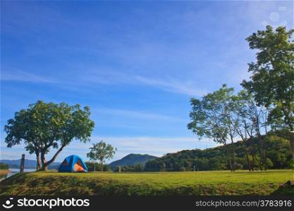 Camping in the wilderness, tent on campground in morning