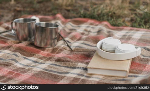 camping outdoors with book mugs hot drinks