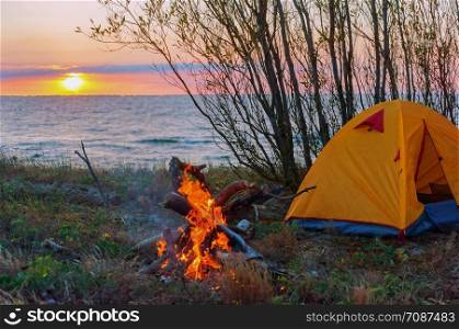camping tent at sunset, the camping on the shore of the sea. the camping on the shore of the sea, camping tent at sunset