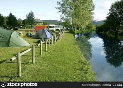 Camping tent field over green grass outdoor field