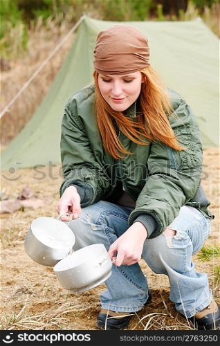 Camping tent happy woman washing dishes in nature