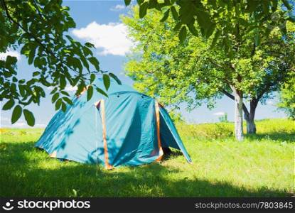 camping tent standing in the apple garden