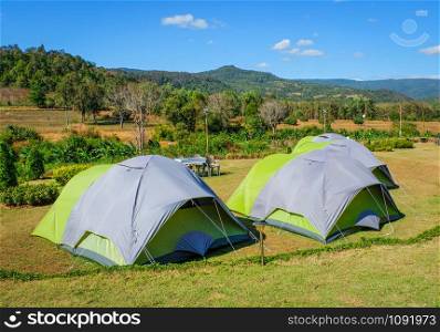 Camping tent tourist on hill mountains background