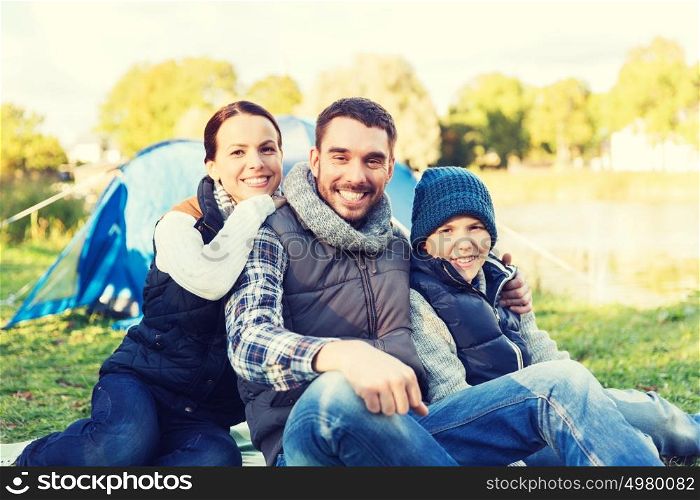 camping, tourism, hike and people concept - happy family over tent at camp site. happy family with tent at camp site
