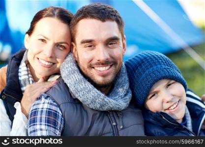 camping, tourism, hike and people concept - happy family over tent at camp site