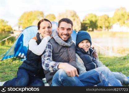camping, tourism, hike and people concept - happy family over tent at camp site