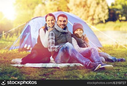 camping, tourism, hike and people concept - happy family over tent at camp site. happy family with tent at camp site