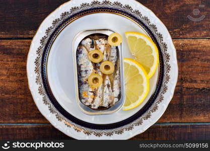 Can of canned oil sardines on a elegant plate. Healthy meal