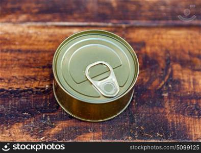 Can of preserves on an aged wooden background