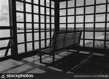 Can take relax on the wooden bench with view of sea in black and white concept