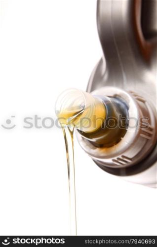 Can with car engine oil pouring in front white background
