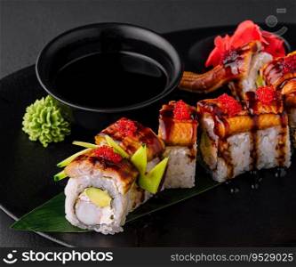 Canada roll with snow crab on black plate