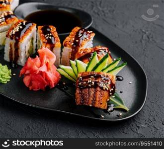 Canadian roll with eel on black plate from stone