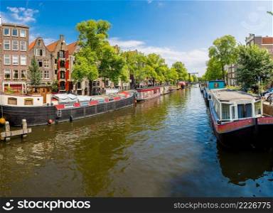 Canal and bridge in Amsterdam. Amsterdam is the capital  of the Netherlands in a summer day