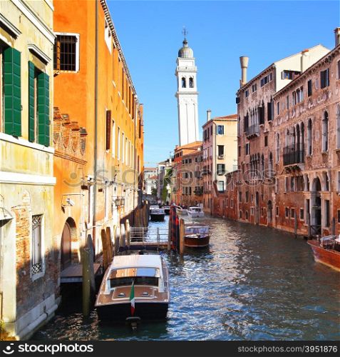 Canal and famous leaning bell tower in Venice, Italy
