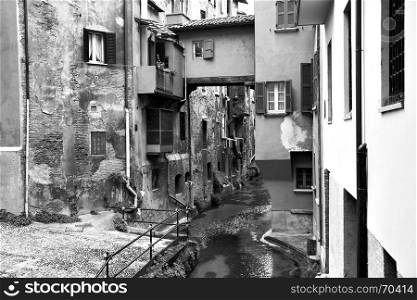 Canal in the old town of Bologna, Italy. Black and white image