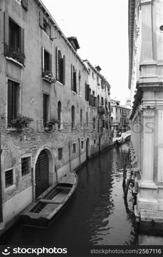 Canal with boat and buildings in Venice, Italy.