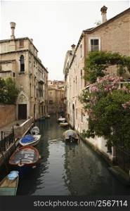 Canal with boats and buildings in Venice, Italy.