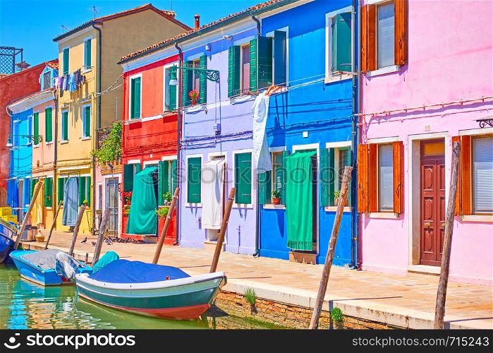Canal with boats and colorful houses in Burano Island, Venice, Italy