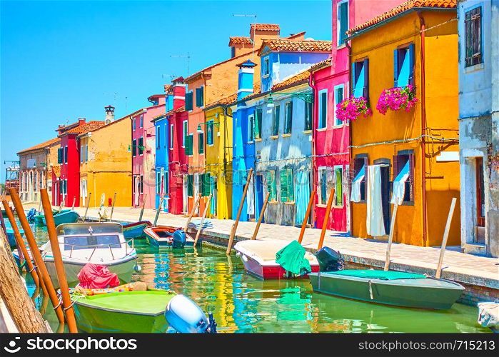 Canal with boats and picturesque houses in Burano, Venice, Italy