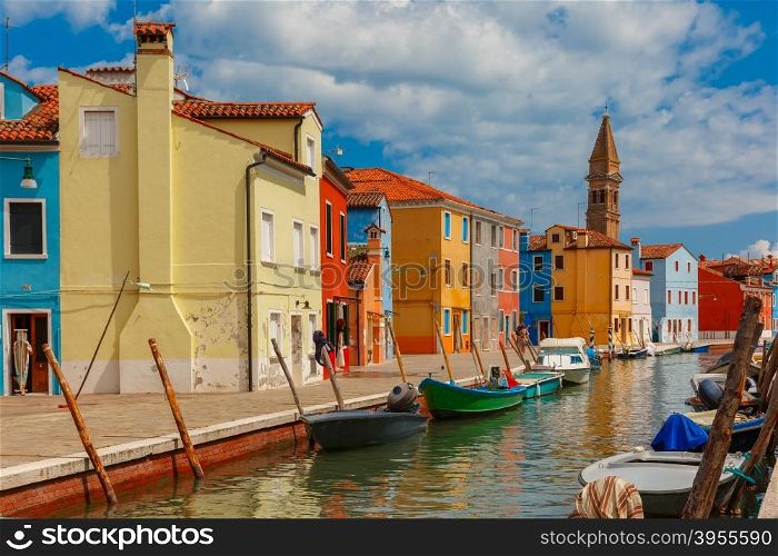 Canal with colorful houses and church on the famous island Burano, Venice, Italy