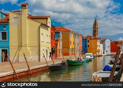 Canal with colorful houses and church on the famous island Burano, Venice, Italy