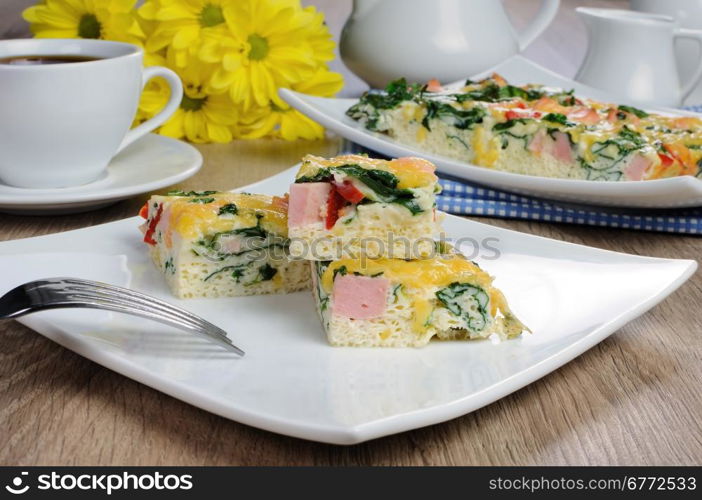 Canape of omelet with spinach, sausage and a cup of coffee