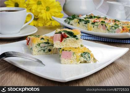Canape of omelet with spinach, sausage and a cup of coffee