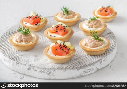Canapes with cream cheese, cod roe and salmon