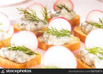 canapes with cream cheese pasta with dill and radish. canapes with radish