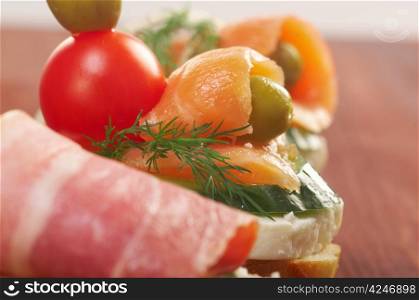 Canapes with smoked salmon ,bacon. Shallow depth-of-field.