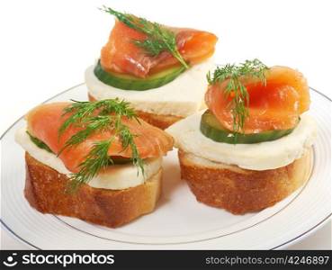 Canapes with smoked salmon,cheese and cucumber. close up