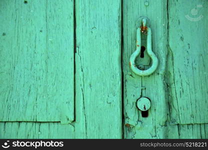 canarias brass brown knocker in a green closed wood door lanzarote abstract spain
