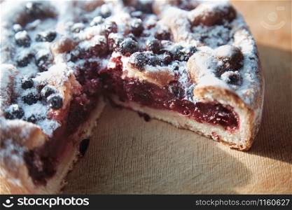 Canberry cake with blackberry on a wooden table