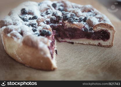 Canberry cake with blackberry on a wooden table