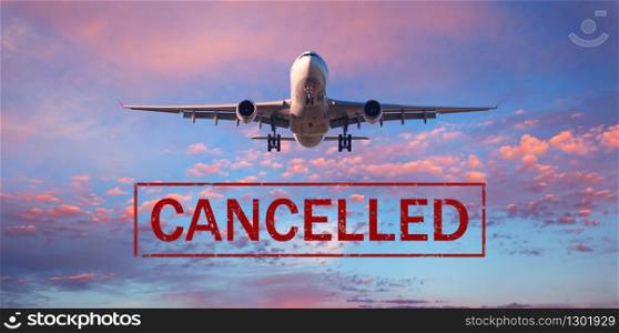 Canceled flights in Europe and USA airports. Travel vacations cancelled because of pandemic of coronavirus. Background of flying passenger airplane. Flight cancellation. Aircraft with text. Covid-19