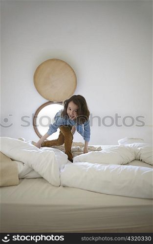 Candid portrait of girl playing on bed