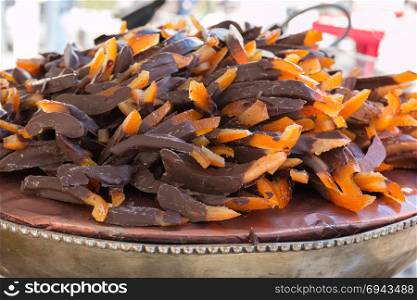 Candied Orange Rind covered with Dark Chocolate on Silver-plated Bowl. Orange Little Sticks of Peel Covered with Chocolate on Silver-pl