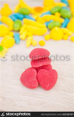 Candies with different shapes and colors on a gray wooden background