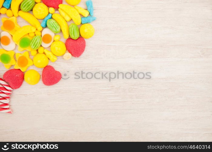 Candies with different shapes and colors on a gray wooden background