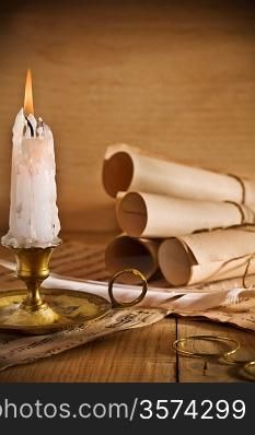 candle and old roll of paper
