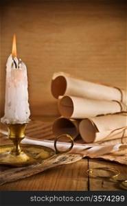 candle and old roll of paper