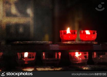 Candle burning inside an old Catholic church - Vintage dirty look