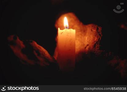 Candle flame. Candle flame with light reflected on a stone