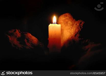 Candle flame. Candle flame with light reflected on a stone