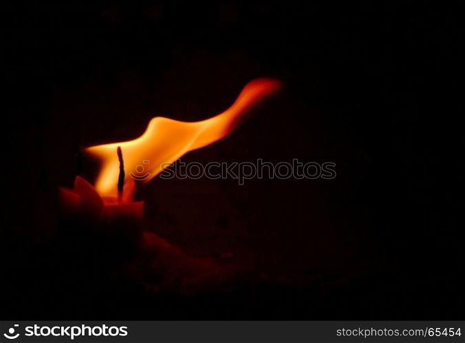 Candle flame on black background.