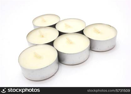 Candle floating aromatic in the metal case of white color on a white background