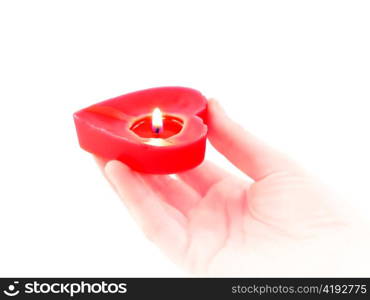 candle heart in a human hand on white background