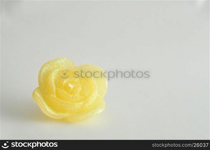 Candle in the shape of a rose isolated on a white background