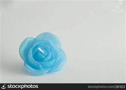 Candle in the shape of a rose isolated on a white background